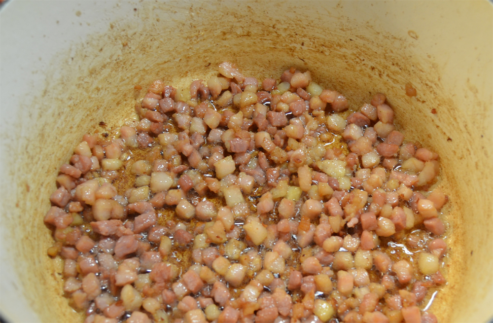 Diced pancetta in a pot.