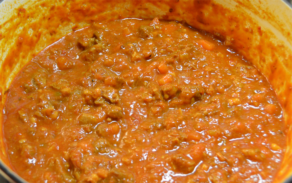 Ragù alla bolognese simmering in a pot.