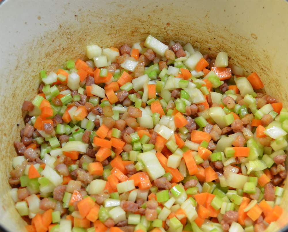 Soffritto of onion, carrot and celery added in with pancetta.